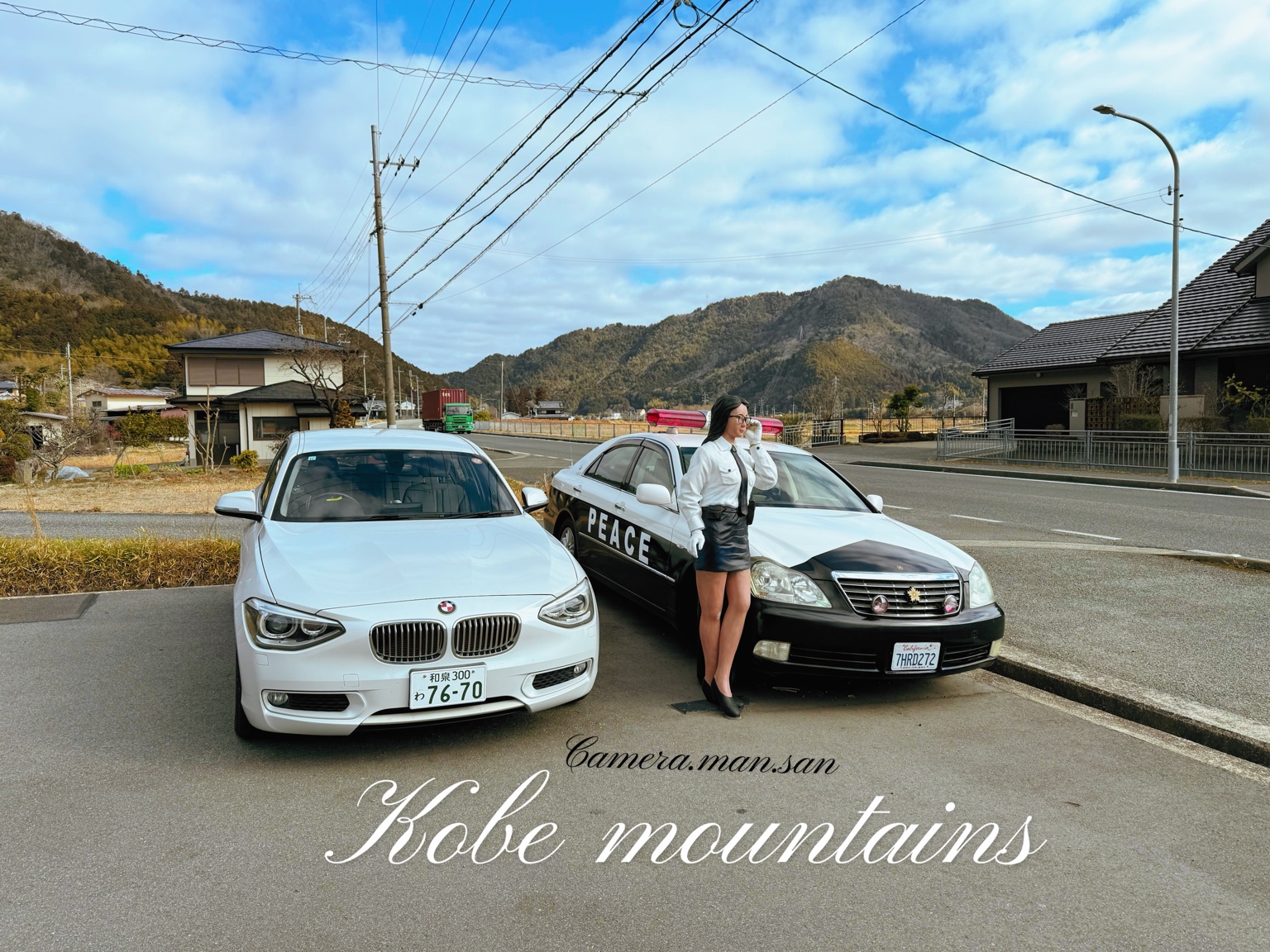 Two cars parked together with mountains in the background