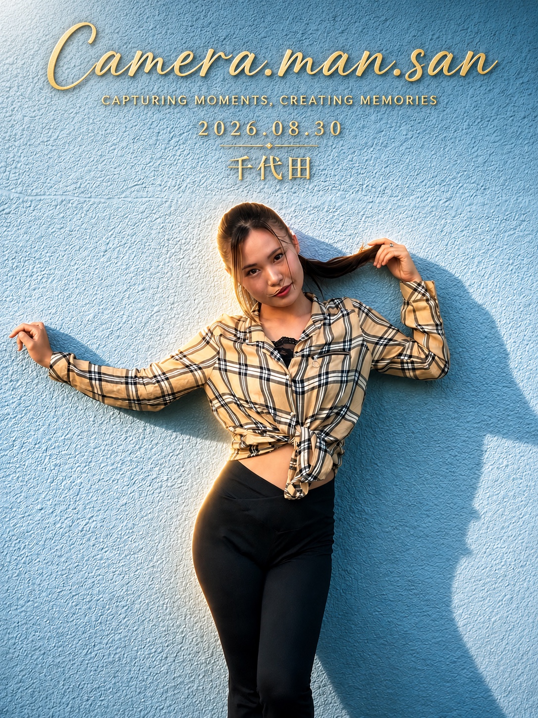 Portrait in a plaid shirt against a textured blue wall