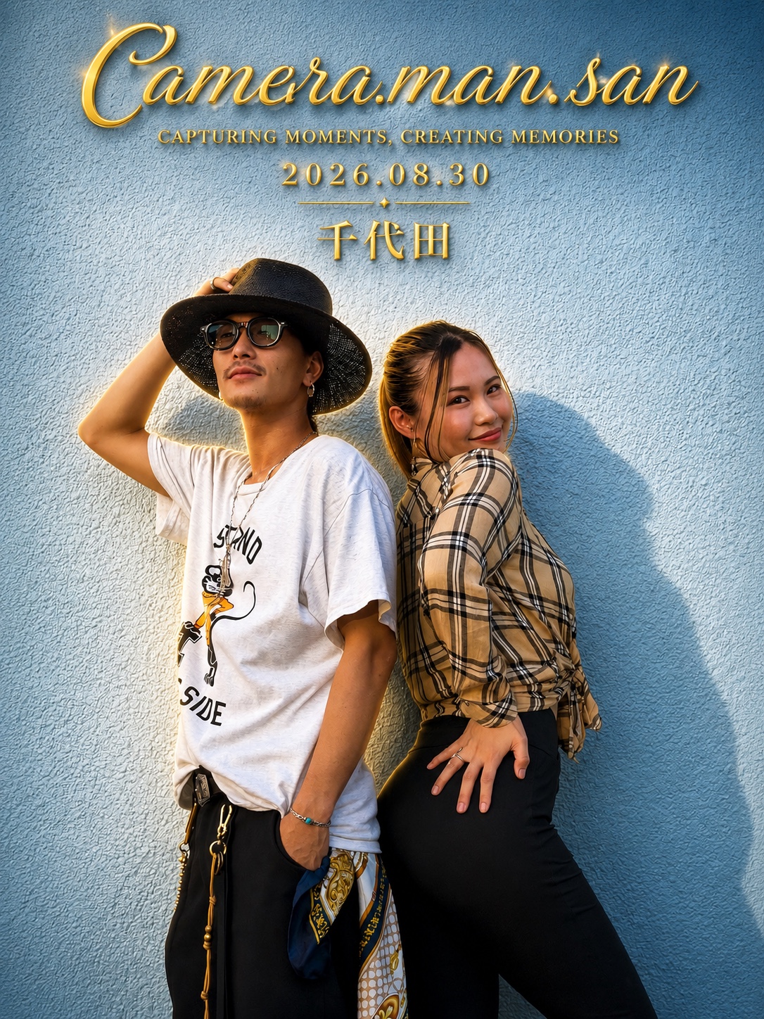 Two people posing back to back against a blue wall